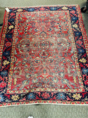 Persian Heriz Wool Rug - Red, with blue and ocher accents.