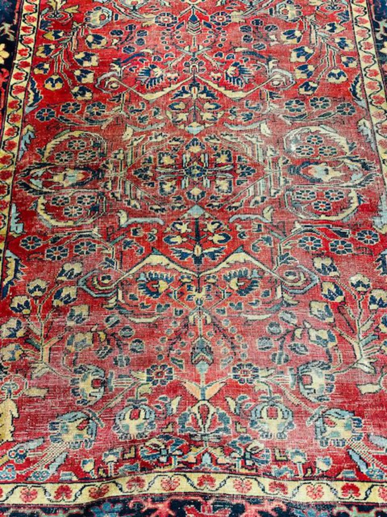 Persian Heriz Wool Rug - Red, with blue and ocher accents.