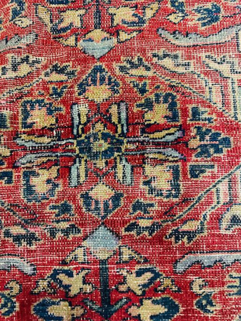 Persian Heriz Wool Rug - Red, with blue and ocher accents.