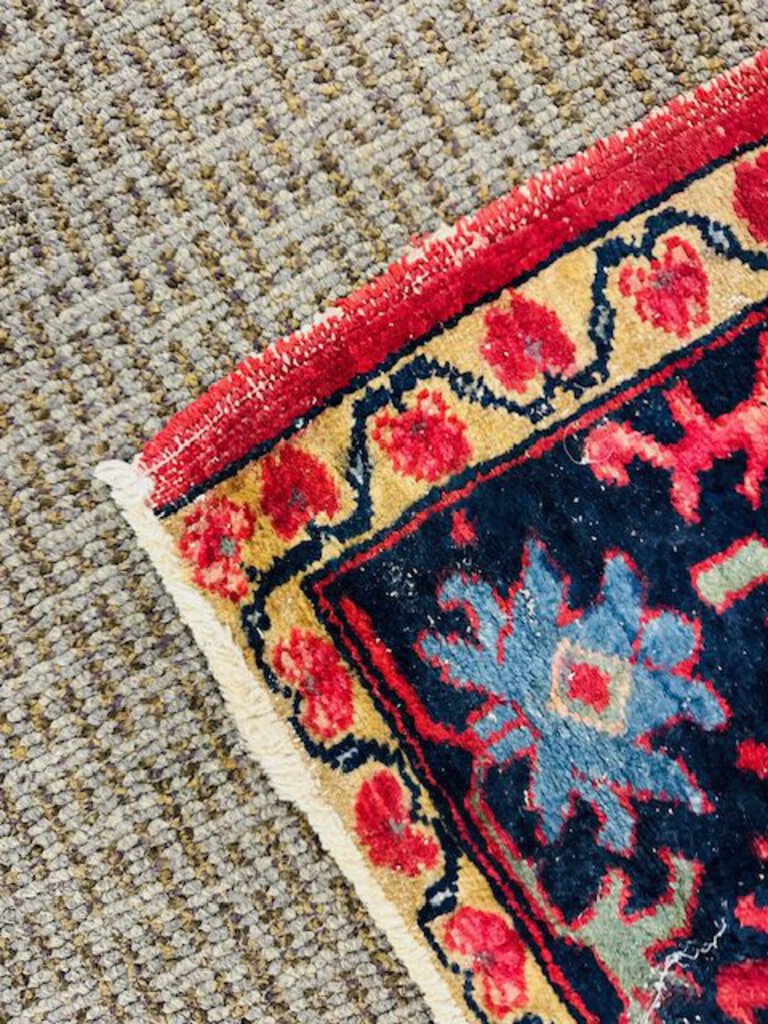 Persian Heriz Wool Rug - Red, with blue and ocher accents.