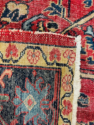 Persian Heriz Wool Rug - Red, with blue and ocher accents.