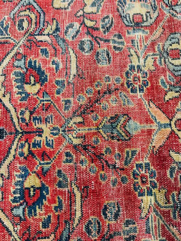 Persian Heriz Wool Rug - Red, with blue and ocher accents.