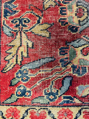 Persian Heriz Wool Rug - Red, with blue and ocher accents.