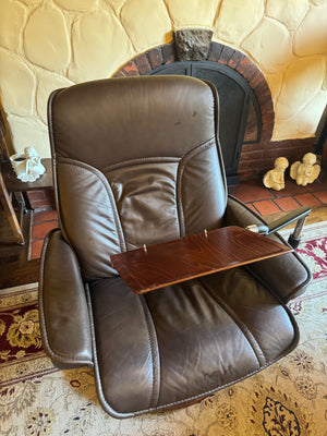 Ekornes Stressless recliner features a signature swivel base and a matching ottoman