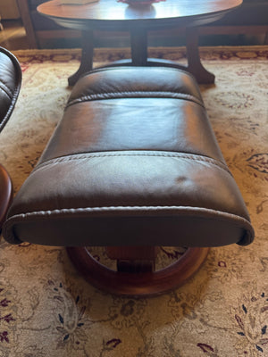 Ekornes Stressless recliner features a signature swivel base and a matching ottoman