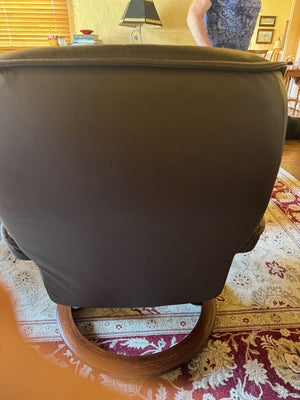 Ekornes Stressless recliner features a signature swivel base and a matching ottoman