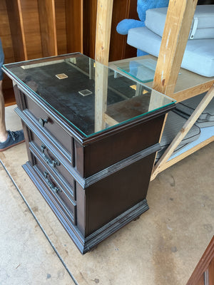 Wooden three drawer nightstand with glass top measuring 28 by by 29 x 18