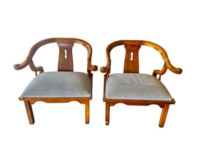 Pair of Ming style wood armchairs featuring sculptural horseshoe backs with brass detailing