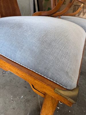 Pair of Ming style wood armchairs featuring sculptural horseshoe backs with brass detailing