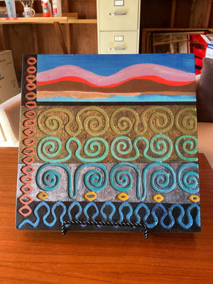 Painted Abstract Wooden Panel Wall Art with Raised Spiral & Wave Motifs on Small Black Metal Easel