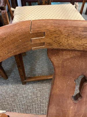Pair of Ming style wood armchairs featuring sculptural horseshoe backs with brass detailing