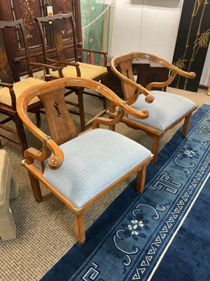 Pair of Ming style wood armchairs featuring sculptural horseshoe backs with brass detailing