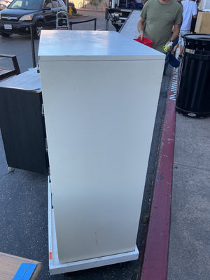 This is a chest of drawers five drawers by Eden furniture company painted tile fronts with black metal handles rolling base not included measuring 30 x 18 x 46