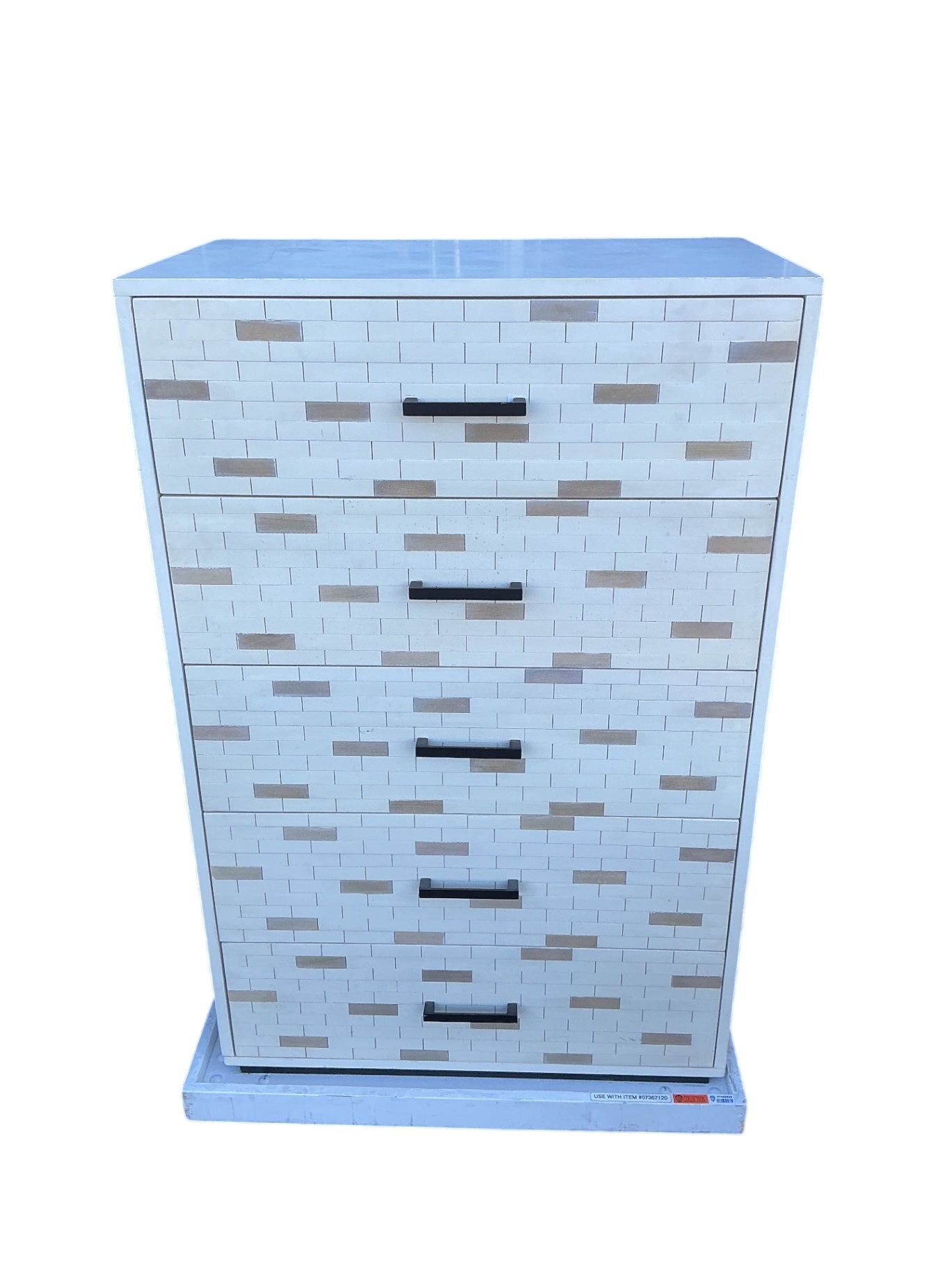 This is a chest of drawers five drawers by Eden furniture company painted tile fronts with black metal handles rolling base not included measuring 30 x 18 x 46