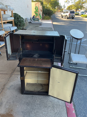 This is an antique bar with retractable dual doors, pullout copper shelf and insulated icebox style bottom measuring 29 x 50 x 29