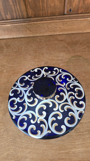 Blue glass candy dish with gold/white pattern