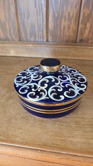 Blue glass candy dish with gold/white pattern