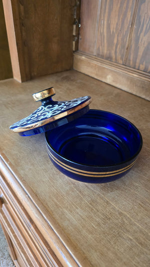 Blue glass candy dish with gold/white pattern